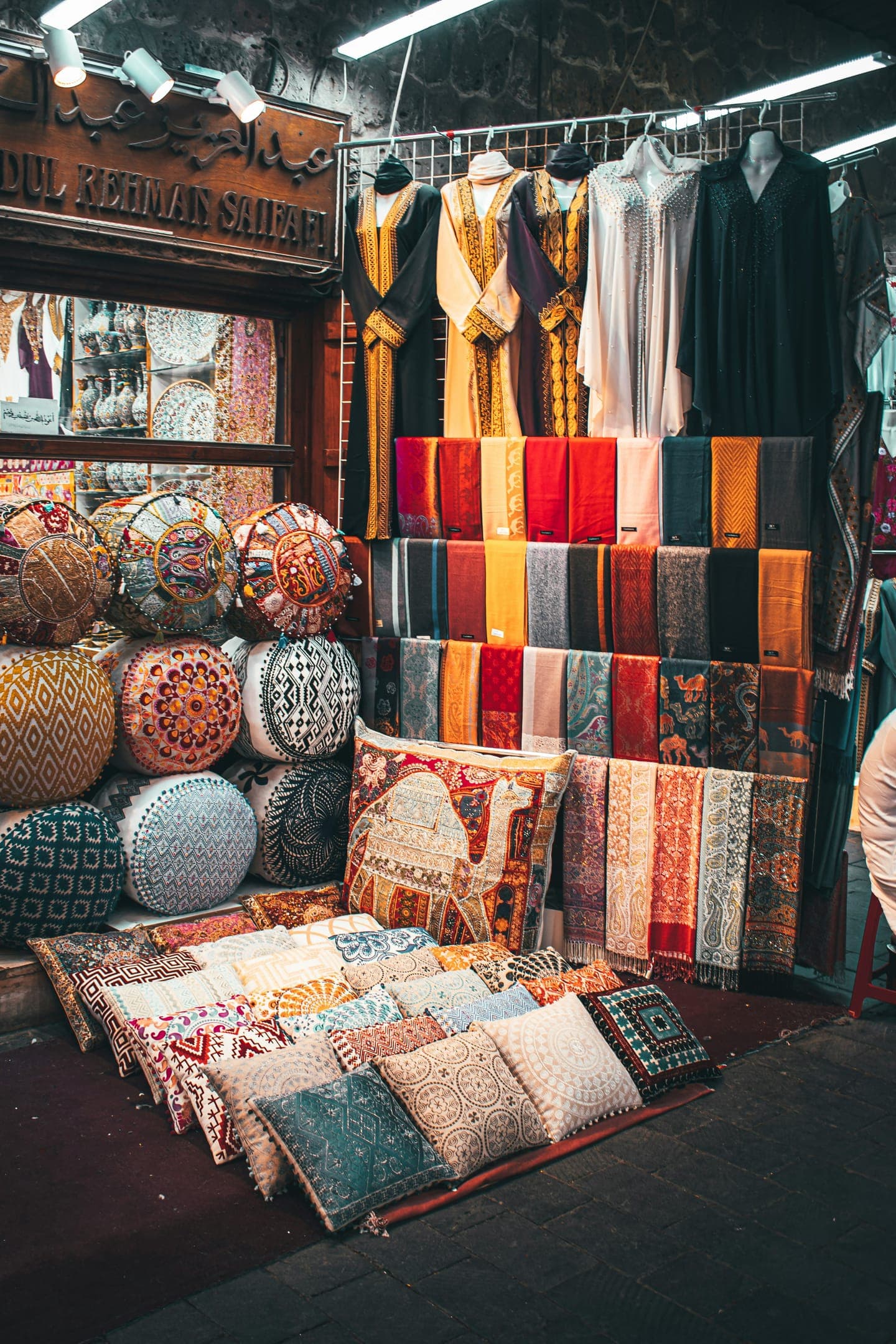 Cushions, leather poufs and blankets piled in a shop