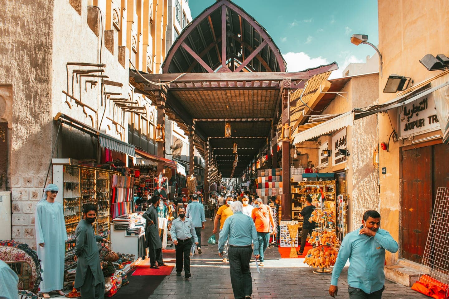 Shoppers walking through a covered market street