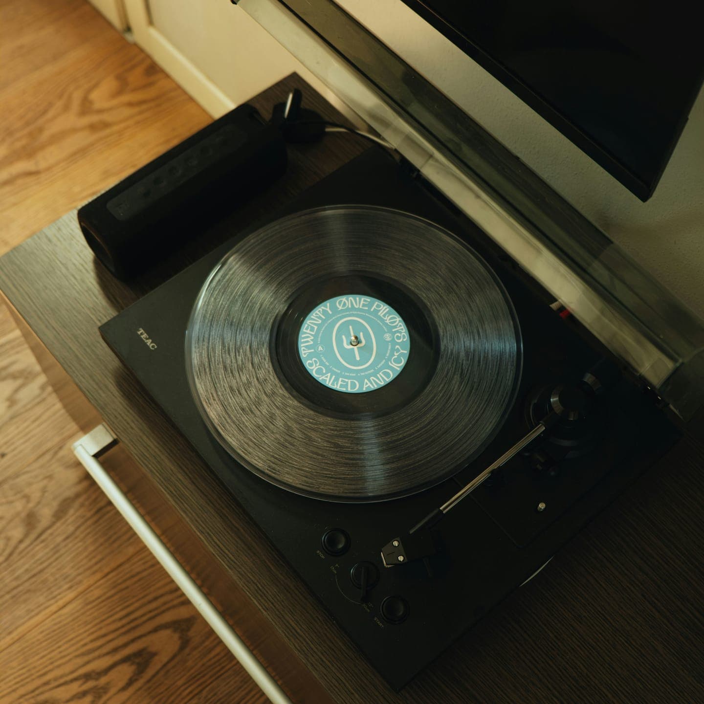 A record player with a pale blue label vinyl, seen from above