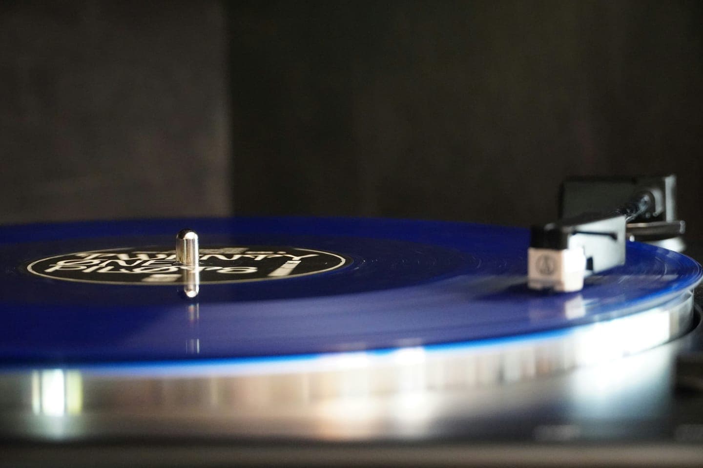 A blue vinyl record spinning on a turntable
