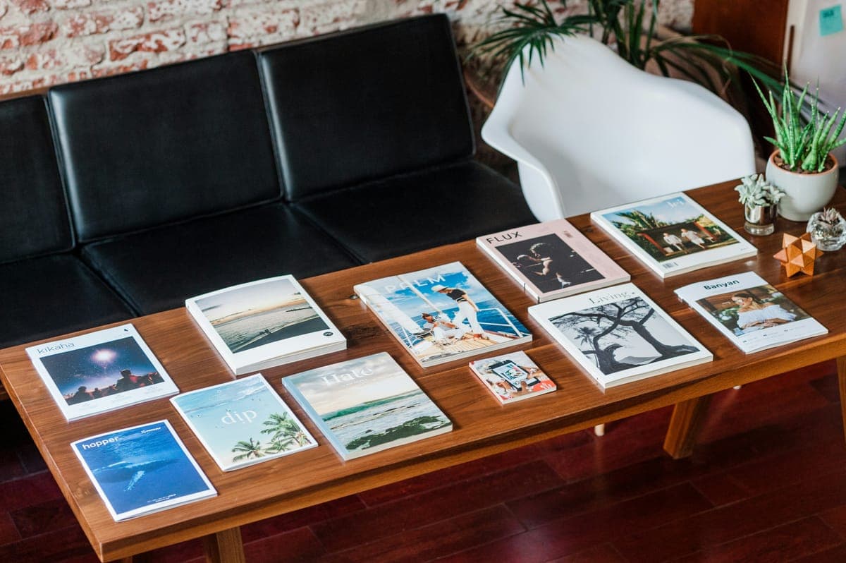 Printed photographs laid out on a wooden coffee table